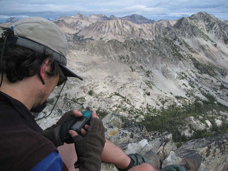 IMG_3890.jpg - Rickey playing with his GPS on the top of El Capitan.  The top of El Capitan is quite small.  There was only room for 3 or 4 people and when standing up - you felt like you were going to fall off.