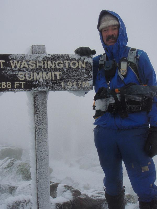 PA060134.JPG - Dave Socky at the summit of Mt Washington.  The wind is gusting between 30 to 40 MPH.  We figured the effective temperature to be around 20 degrees.  Photo by Tommy Bell